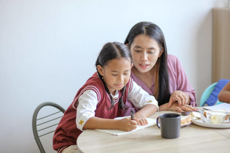 a mother teaching her child psle math