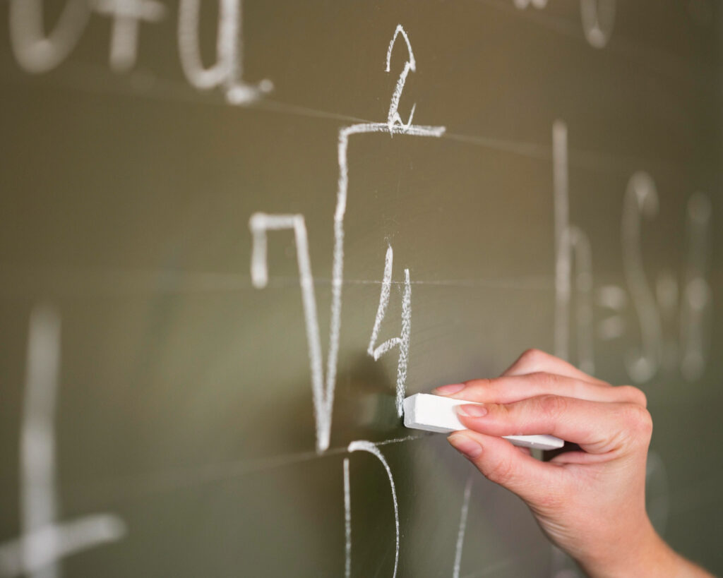A Maths and E Maths teaching on chalkboard